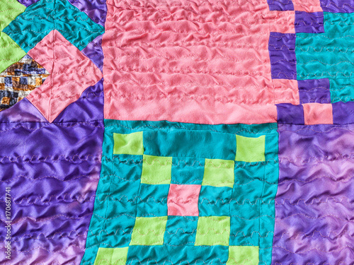 square pieces of fabrics in stitched patchwork