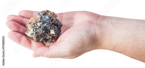 piece of zinc and lead mineral ore on male palm
