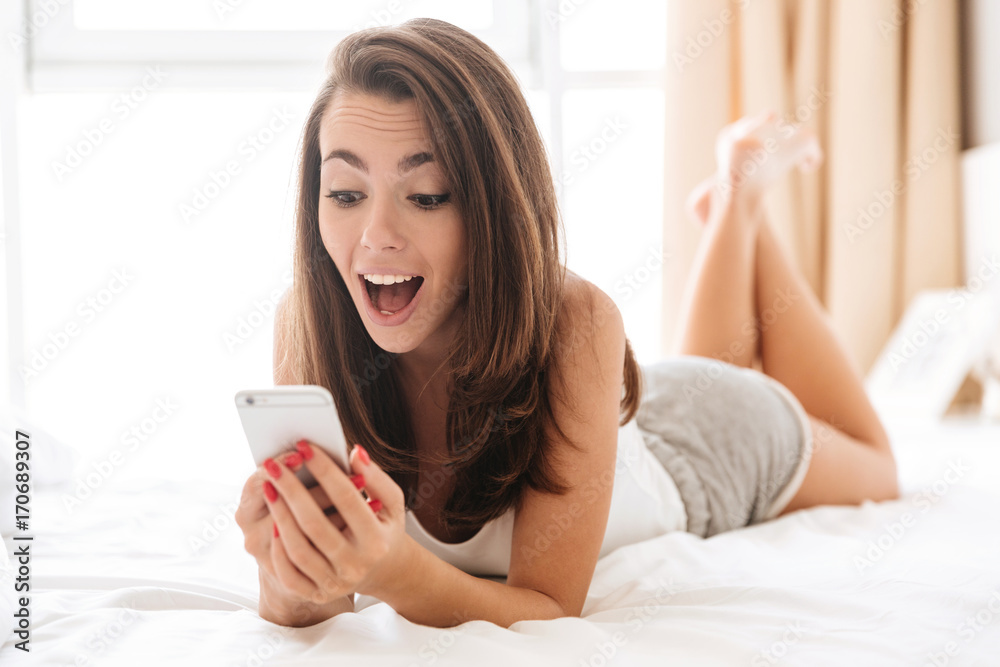 Close up portrait of happy excited woman using mobile phone Close up portrait of happy excited woman using mobile phone
