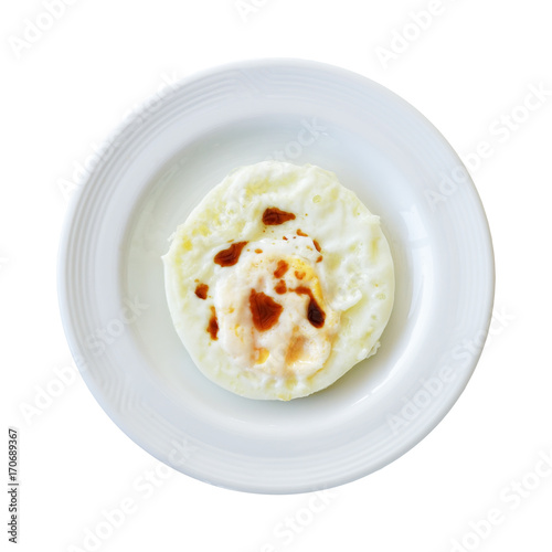 Fried egg with sauce and fat on top isolated on white background with clipping