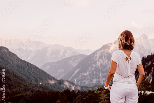 Caucasian tourist standing and looking at the mountain view