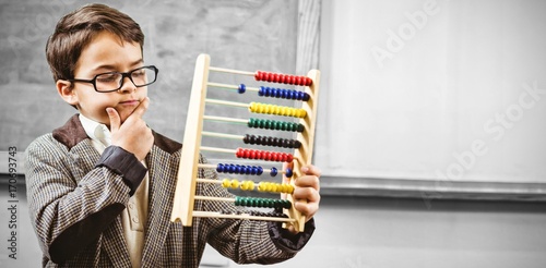 Pupil dressed up as teacher holding abacus photo