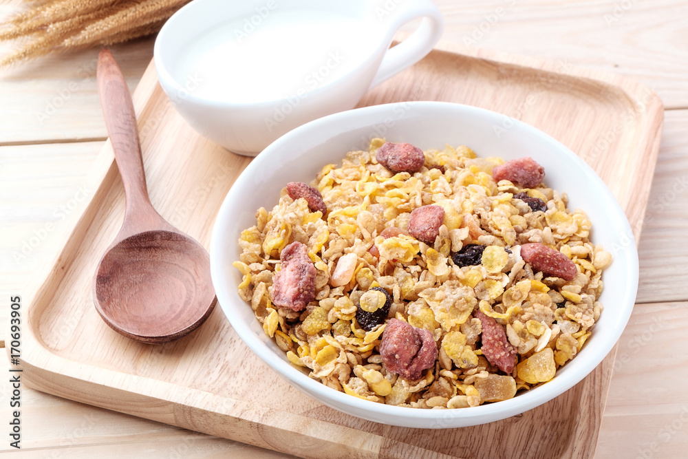 cornflakes and dry fruits on wooden background cornflakes and dry fruits on wooden background