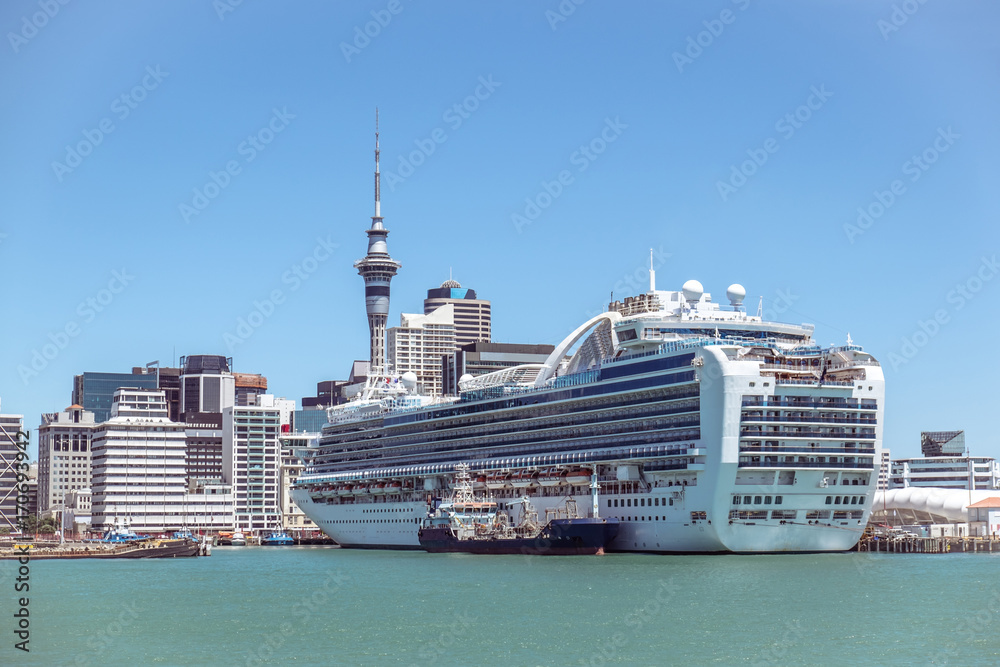 Naklejka premium Auckland CBD skyscrapers and Sky Tower with a cruise ship in New Zealand, NZ
