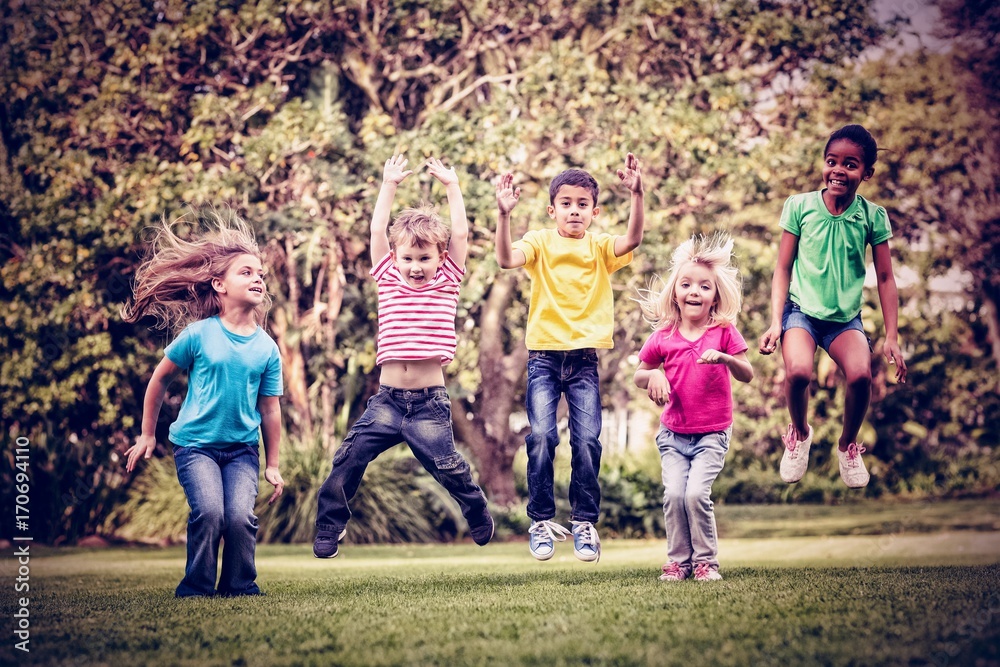 Fototapeta premium Happy children jumping at park