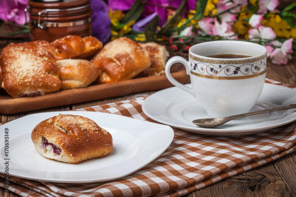 Buns with berries on a wooden table. Buns with berries on a wooden table.