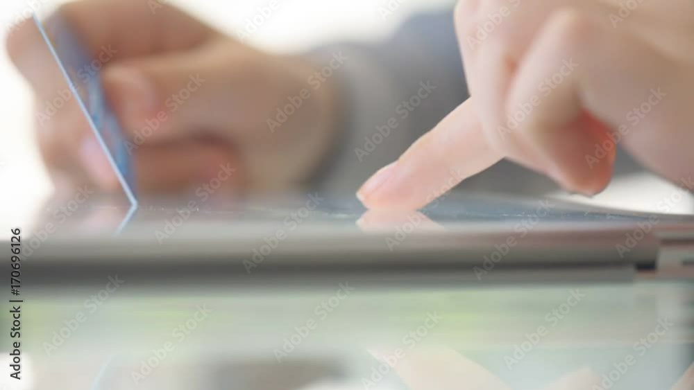 Woman holding a credit card and using cell phone for online shopping. Woman holding a credit card and using cell phone for online shopping.