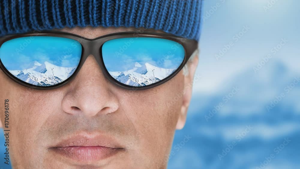 Cinemagraph - Skier man wearing sunglasses relaxing in the mountain . Motion Photo. Cinemagraph - Skier man wearing sunglasses relaxing in the mountain . Motion Photo.