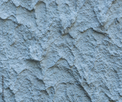 Rough stucco textured background of a wall with natural light. Abstract texture of plaster.