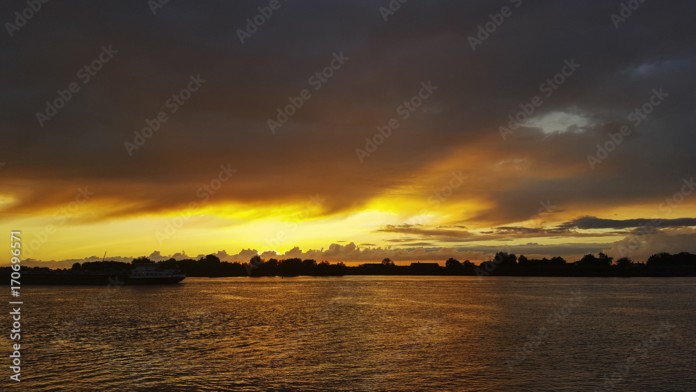 Sunset over Dutch river Lek, Streefkerk, South Holland, Netherlands