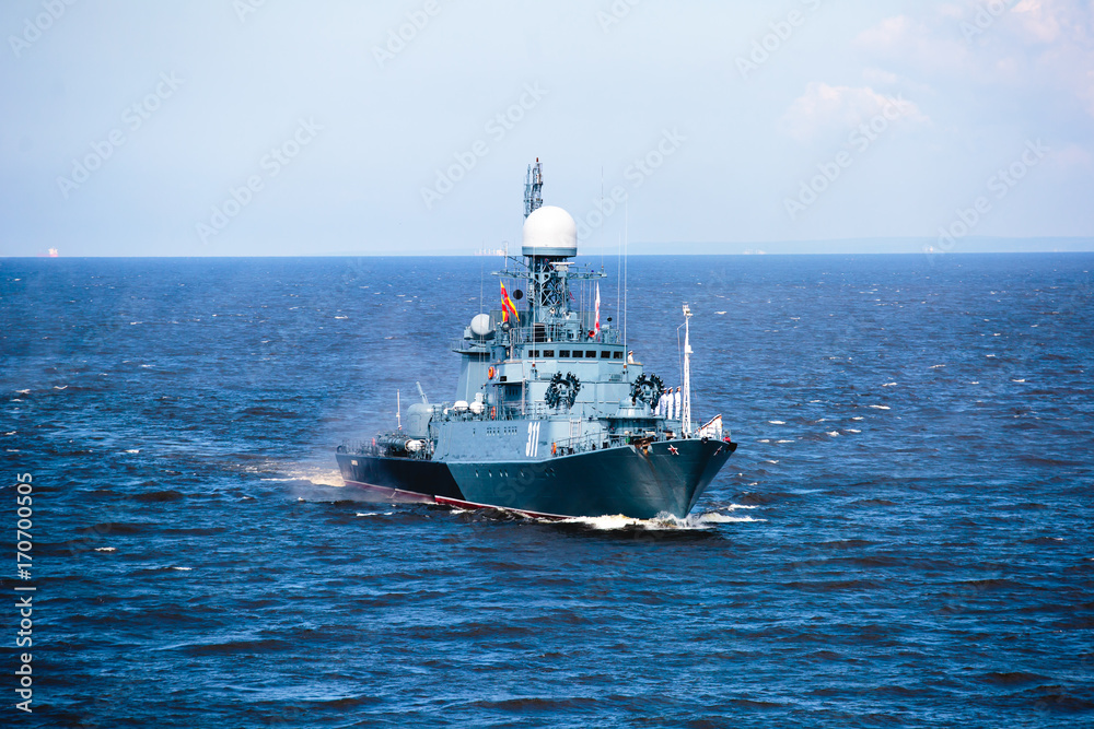 A line of modern russian military naval battleships warships in the row, northern fleet and baltic sea fleet in the open sea A line of modern russian military naval battleships warships in the row, northern fleet and baltic sea fleet in the open sea