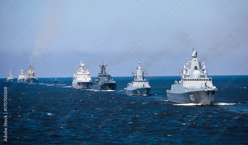 A line of modern russian military naval battleships warships in the row, northern fleet and baltic sea fleet in the open sea