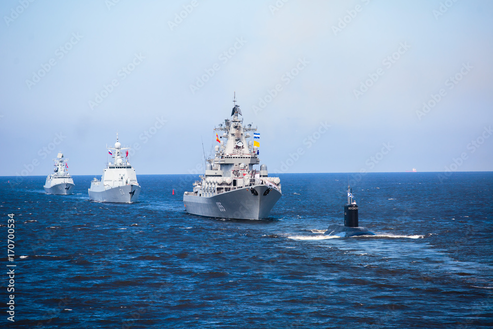 A line of modern russian military naval battleships warships in the row, northern fleet and baltic sea fleet in the open sea A line of modern russian military naval battleships warships in the row, northern fleet and baltic sea fleet in the open sea