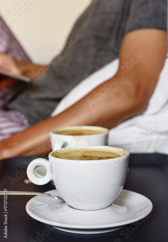 young man with a coffee using a tablet