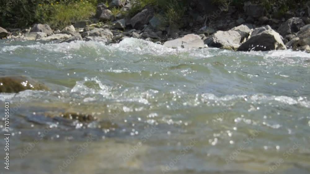A mountain river flows along the forest A mountain river flows along the forest