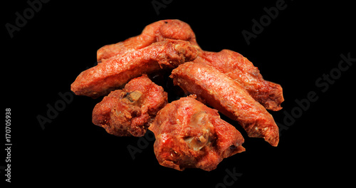 Grilled chicken wings isolated on black background