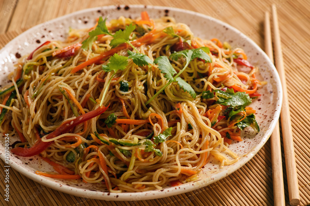 Asian salad with rice noodles and vegetables, korean style cuisine. Asian salad with rice noodles and vegetables, korean style cuisine.