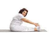 Mature woman stretching on an exercise mat