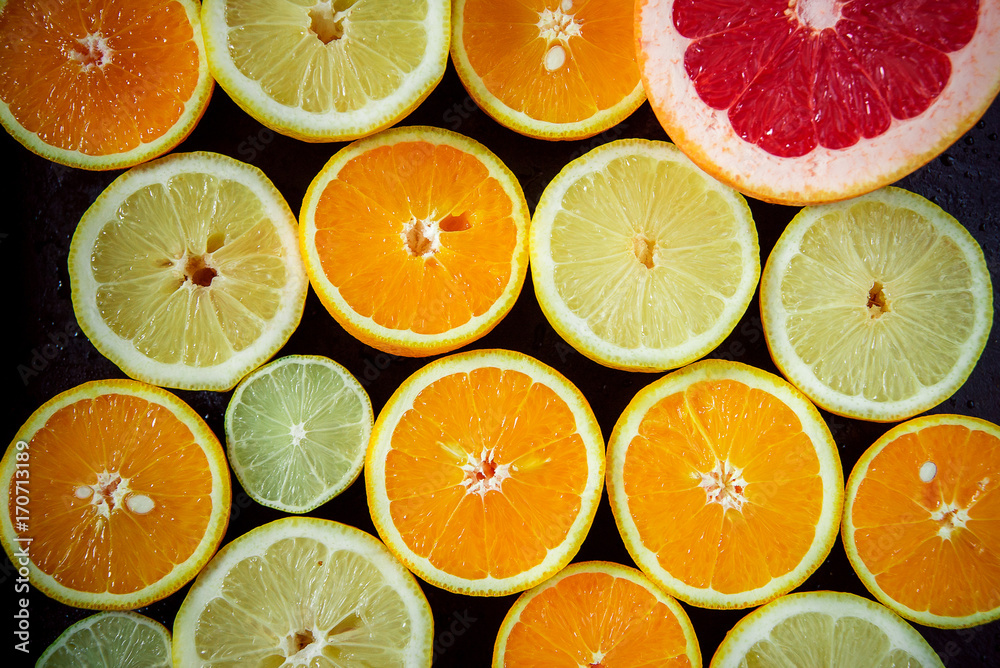 Sliced citrus fruits, vitamins, oranges, grapefruits, limes, juicy fruits background Sliced citrus fruits, vitamins, oranges, grapefruits, limes, juicy fruits background