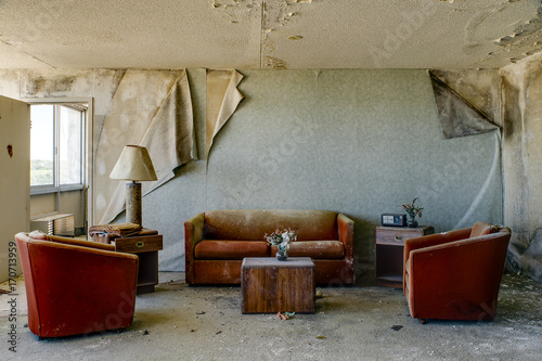 Intact Lodging Room with Burnt Orange Chairs & Couch - Abandoned Hotel photo