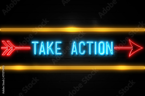 Take Action  - fluorescent Neon Sign on brickwall Front view photo