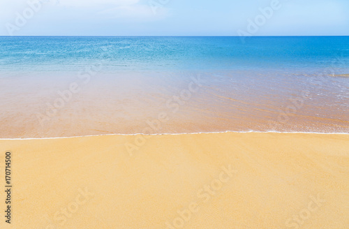 white soft wave on empty tropical beach and blue sea with blue sky background