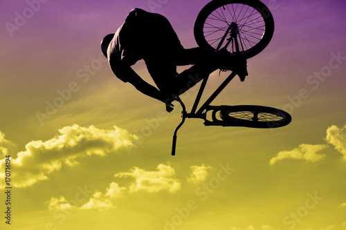 Bikers jumping on a ramp in the park
