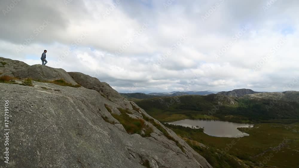 Man is hiking on the top of a mountain in Norway Man is hiking on the top of a mountain in Norway