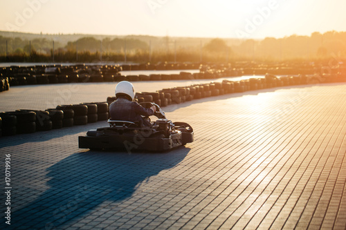 Karting competition or racing cars riding for victory on a racetrack