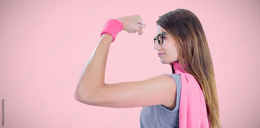 Composite image of woman in superhero costume while flexing Composite image of woman in superhero costume while flexing