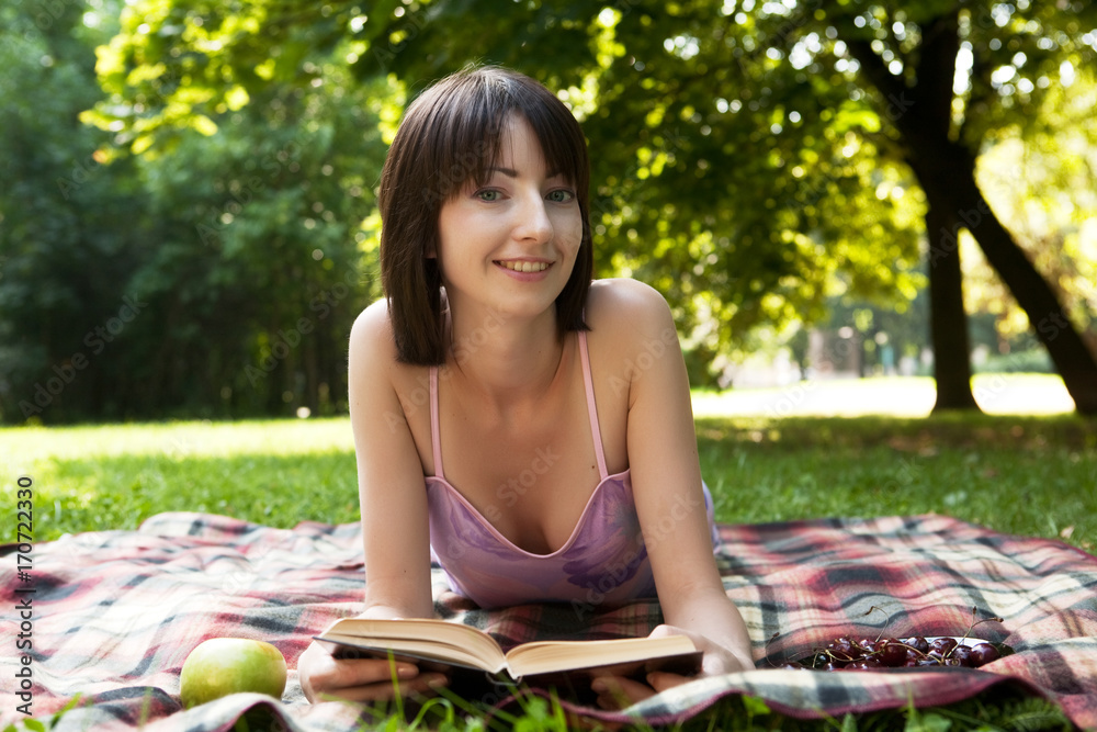 Beautiful young woman reading outdoor Beautiful young woman reading outdoor