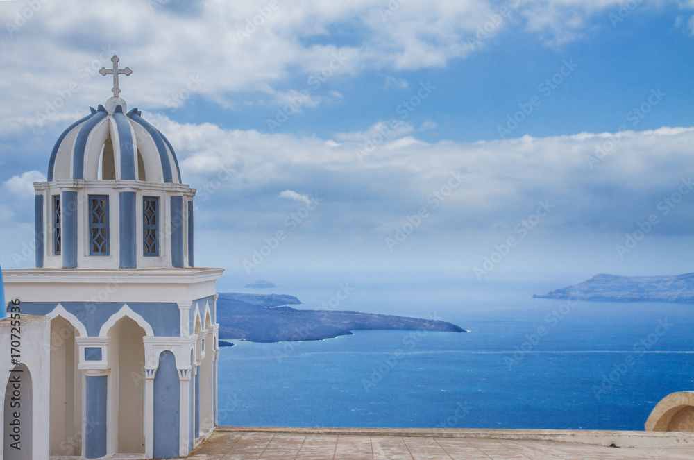 Obraz premium white and blue belfries against volcano caldera, beautiful details of Santorini island, Greece