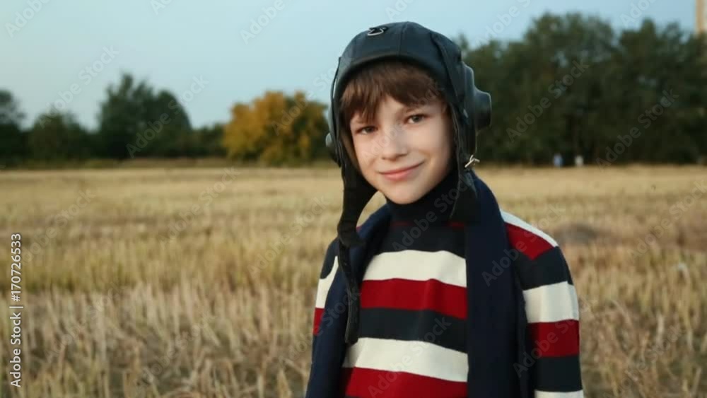 young pilot or aviator boy plays and smile with his carboard airplane, close up portrait young pilot or aviator boy plays and smile with his carboard airplane, close up portrait