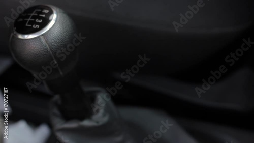 manual gear shift knob on a vehicle. hand of driver, driving car shifting gears