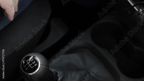 manual gear shift knob on a vehicle. hand of driver, driving car shifting gears