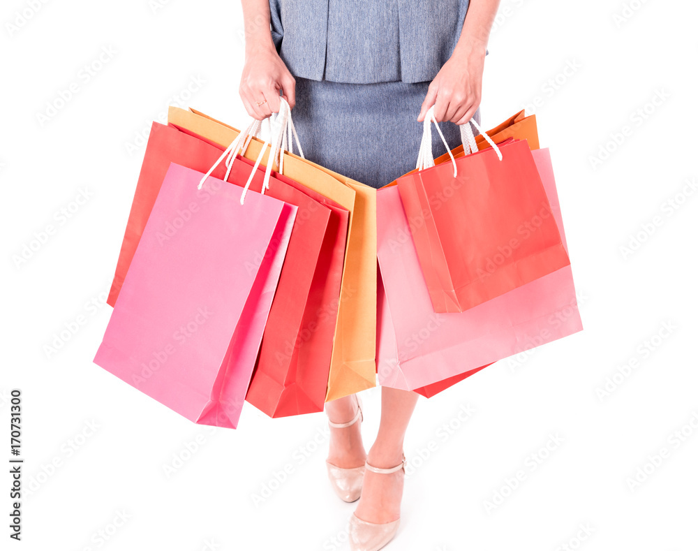 Closed up ,Hands of business women carrying colorful shopping bags isolated on white background.