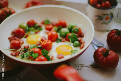 fried eggs with mixed vegetables in a frying pan