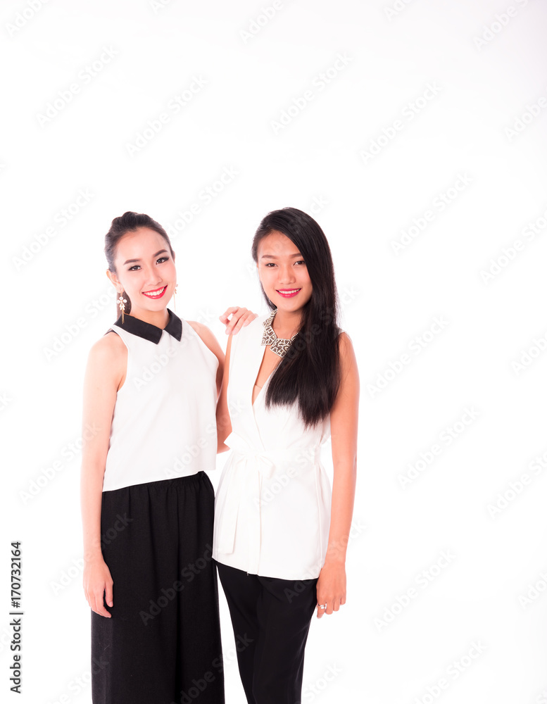 portrait of two attractive caucasian and asian smiling women isolated on white studio portrait of two attractive caucasian and asian smiling women isolated on white studio