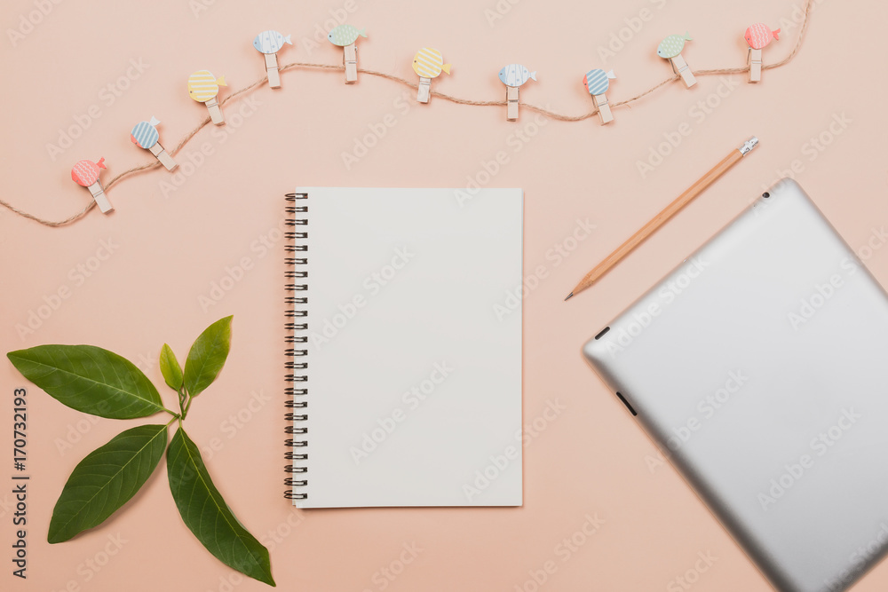 Flat lay empty book and pencil, tablet for design work with clipper and small cactus on yellow pastel color background. Flat lay empty book and pencil, tablet for design work with clipper and small cactus on yellow pastel color background.