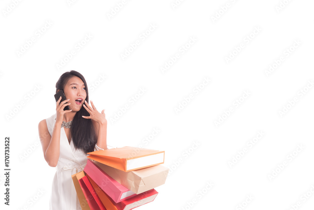 Cheerful shopping woman of Asian holding bags. Shopping smart business woman happy smiling holding colorful shopping bags with smart phone isolated on white . Fresh young Asian female model Cheerful shopping woman of Asian holding bags. Shopping smart business woman happy smiling holding colorful shopping bags with smart phone isolated on white . Fresh young Asian female model