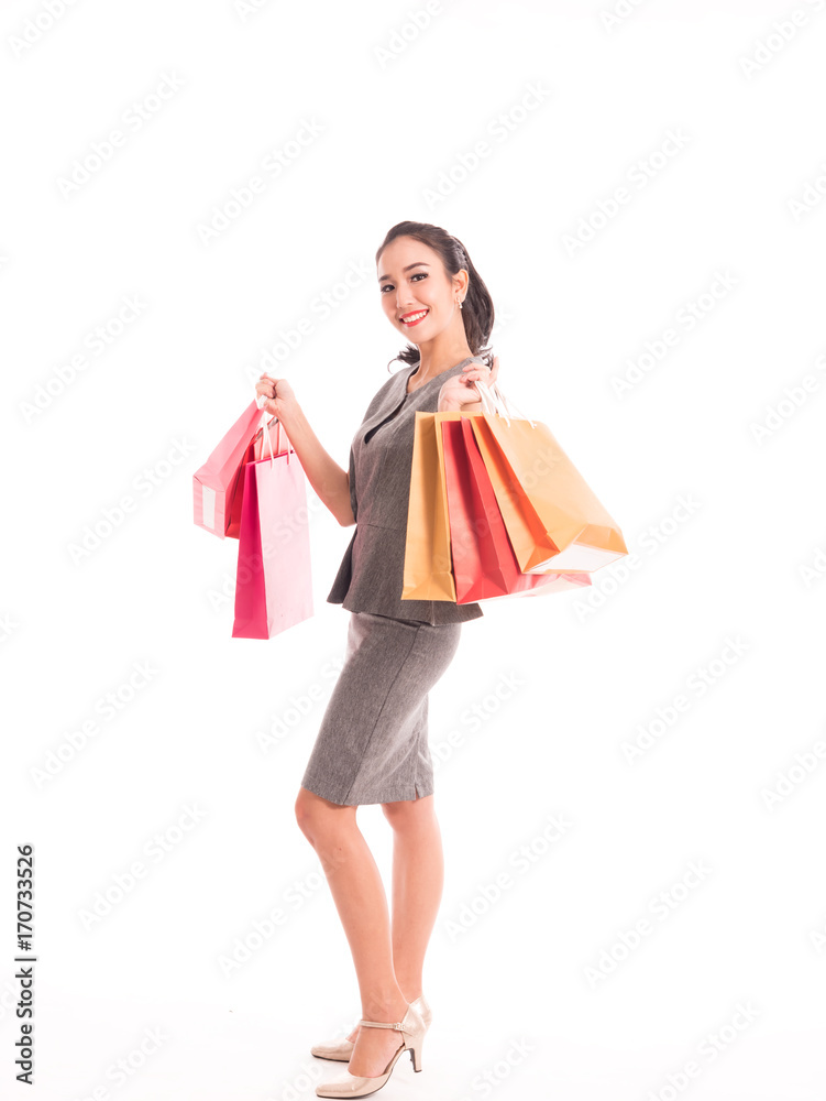Cheerful shopping woman of Asian holding bags. Shopping smart business woman happy smiling holding colorful shopping bags isolated on white . Fresh young Asian female model