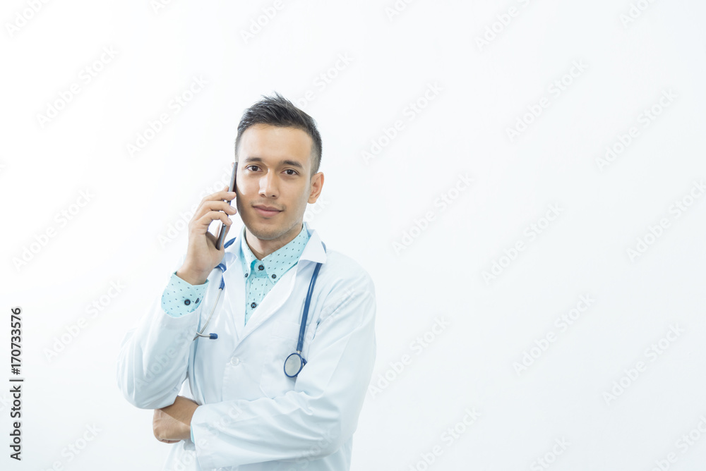 Smart medical man doctor smiling with stethoscope hand working with smart phone,isolated on white and copy space Smart medical man doctor smiling with stethoscope hand working with smart phone,isolated on white and copy space