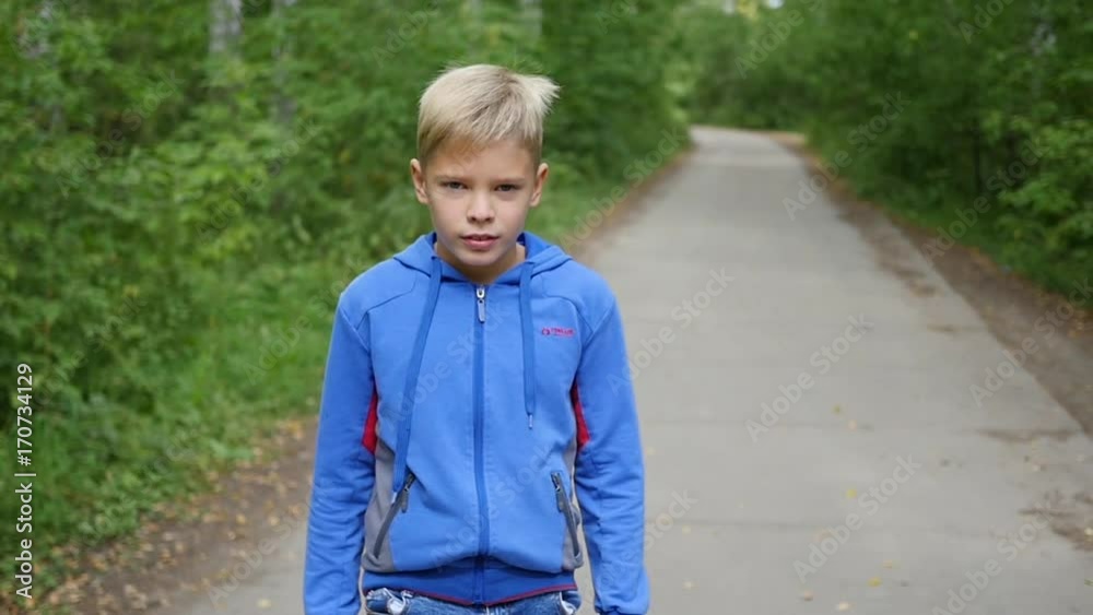 a beautiful child is walking along the alley in the park. Outdoor Activities a beautiful child is walking along the alley in the park. Outdoor Activities