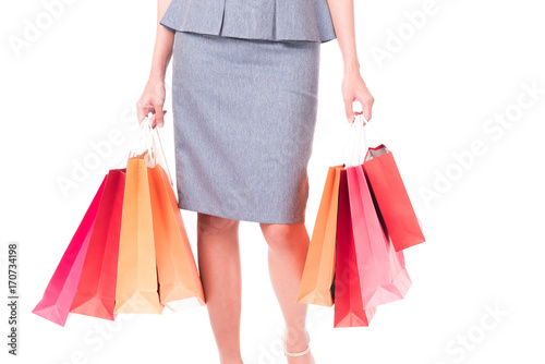 Closed up ,Hands of business women carrying colorful shopping bags isolated on white background