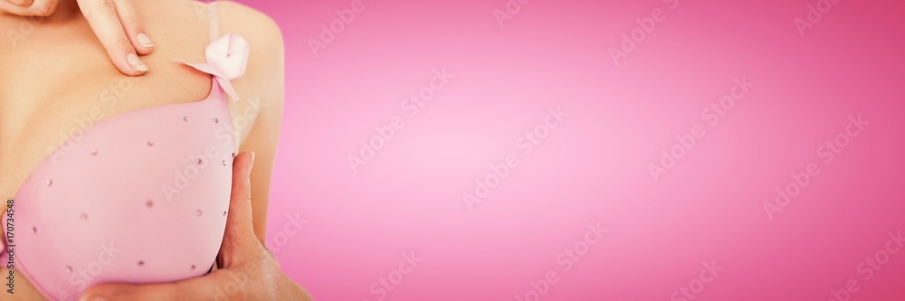Composite image of mid section of woman wearing pink bra for