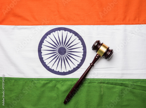 stock photo showing Indian low and jurisdiction - Indian national flag or tricolour with wooden gavel showing concept of law in India
