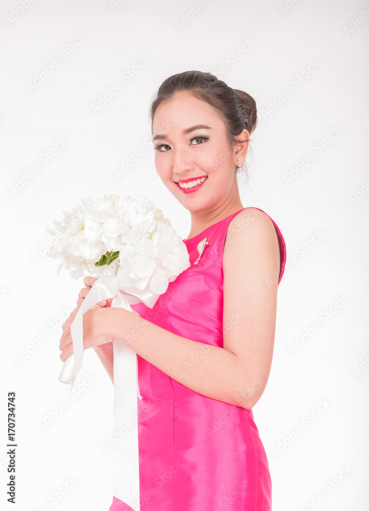 Pretty smiling pink casual wear dress holding white flower bouquet isolated on white in studio Pretty smiling pink casual wear dress holding white flower bouquet isolated on white in studio