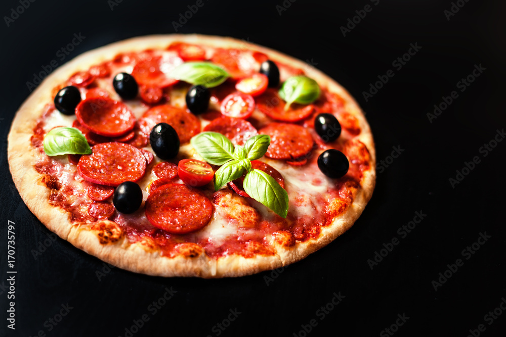 Pizza pepperoni with Ham, Pepperoni and Bacon on dark background with fresh ingredients   for you to design and restaurant menu. Delicious Homemade Meat  pizza.