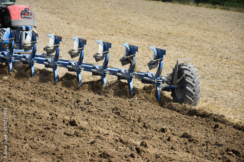 Принти на полотні Tractor plowing a field