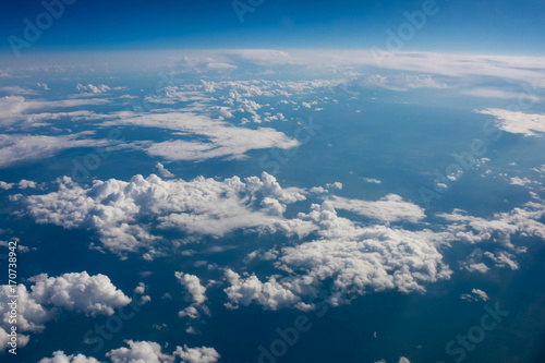 views of clouds and land from airplane window